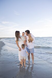 A coastal New England family session with toes in the sand and salty snuggles by the water's edge. North Shore Family Photographer. Deborah Zoe Photography.