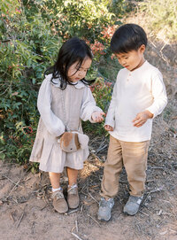 brother and sister exploring nature