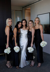 Bridesmaids holding white bouquets during wedding portraits