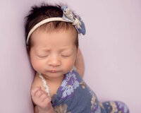 Newborn girl posed and sleepy Cleveland Newborn studio.