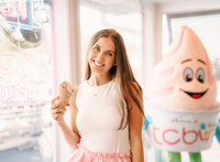Senior portrait in Gulf Shores, Alabama — holding her ice cream cone by the window inside
TCBY.