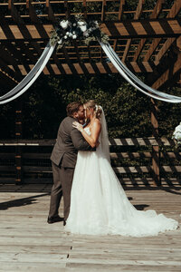 Bride and groom during barn wedding ceremony at Mason Farms in North Georgia, shot by Crimson Conure Photography based in Denver, Colorado and Kennesaw, Georgia
