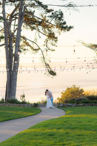 couple dip kiss in front of ocean sunset at seascape resort in aptos california