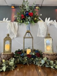 Whimsical moody wedding reception headtable at our Clearwater, Florida event venue, The District - Inclusive decor package featuring moss greenery and fairytale lanterns for a magical atmosphere