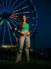 Senior portrait at The Wharf in Orange Beach, Alabama — holding a lollipop