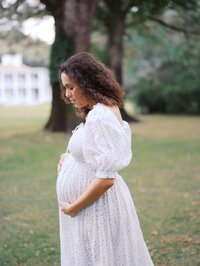 Expecting mom looking down at her belly