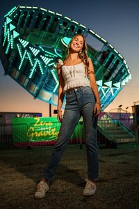 Senior portrait at the Greater Gulf State Fair in Mobile, Alabama — laughing in front of the Tilt-A-
Whirl ride.