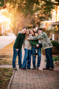 Family hugging at sunset in downtown New Bern North Carolina