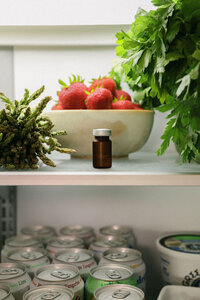 Refrigerator shelf styled with fresh produce, strawberries, and Mochi product