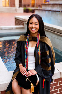Master's degree senior girl sitting beside Lipscomb baptismal fountain for senior pics
