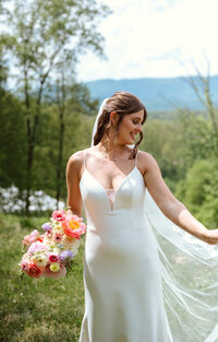 Smiling bride with wedding bouquet at Eastwood Farm & Winery. Florals by Flowergirl Cville and photography from Jessa Rose Moments.
