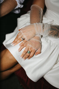 bride wearing wedding gloves