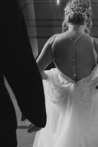 san francisco city hall bride and groom walk through halls after ceremony