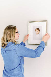 Raleigh photographer hangs heirloom portrait of young boy in Raleigh NC studio