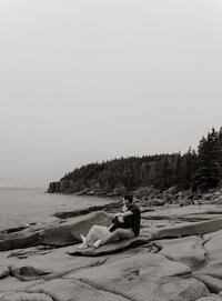 Couple embracing along the rocky coast of Acadia National Park in Maine during a romantic photography session