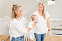 Founder of Snooze Clues consulting with client on putting baby to sleep