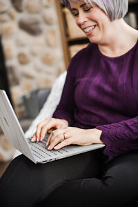 The Social Stager, Heather Cook, typing on a laptop