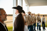 a groom waits at the alter for his bride on their wedding day