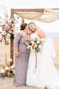 A beautiful beach wedding and a bride and her maid of honor at the alter.