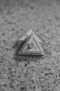 black and white engagement ring on terrazzo tile