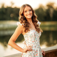 Senior girl posing near a pond at The Oaks at Magnolia Springs Alabama.