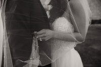 close up shot of the brides ring under her veil during their couples portraits with shelly voss