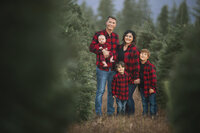 Allie Cline with her husband and children outdoors in the mountains