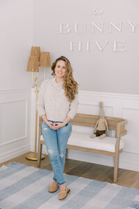 Woman standing in front of the logo sign at The Bunny Hive Mountain View