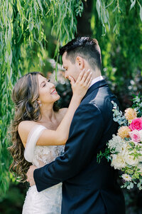 Rustic wedding ceremony at White Ranch in Chico, California, featuring a bride and groom with scenic countryside views, golden fields, and charming rustic architecture.