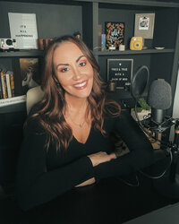 renee bowen at her desk with a podcast microphone and computer