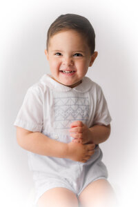 Little boy smiles at the camera during Traditional Heirloom Portrait Photoshoot in Charleston, SC.