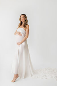 pregnant woman Rosalyn in white dress during fine art maternity session