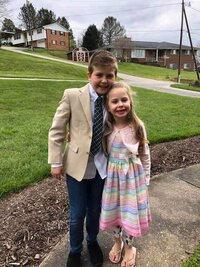 Little boy and girl posing in Sunday best outfits
