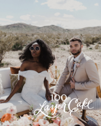 Kohnur modern boho bride in an off-shoulder jumpsuit with natural makeup and voluminous hair with groom in desert landscape featured on 100 Layer Cake.