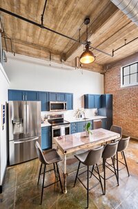 Open concept dining room with exposed brick and open beam ceilings in this vacation rental condo.