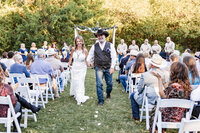 Bride and Groom walking down the isle after ceremony at Azle Deer Cove captured by Graceful Ray Photography