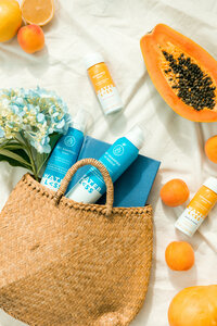 Styled product photography of wellness beverages photographed in a bright, lifestyle flat lay with summer-inspired props