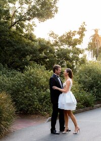 Bride and groom embracing outdoors at sunset