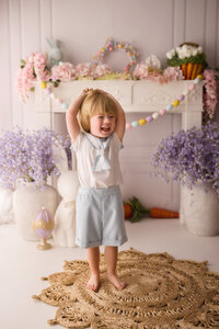 Toddler laughs at the camera during Easter Mini Session at Holy City Babies Portrait Studio in Charleston, SC.