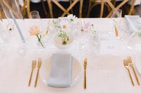 Elegant reception place setting with bud vase florals by Flowergirl Cville at King Family Vineyard wedding, Crozet Virginia | Photo by Paige Ryan Photography