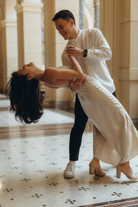 Very classy couple dancing in the grand hall of the National Museum in Prague - cinematic love story captured on 35mm film by Lucie Muse