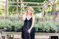 Girl in black dress sitting in Connecticut flower garden