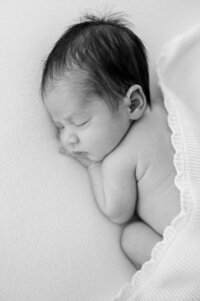 Tiny newborn sleeping peacefully during in-home session South Florida