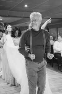wedding pastor starting congo line on boat wedding reception in san francisco bay.