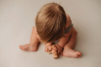 Baby poses for Milestone Portraits at Holy City Babies Portrait Studio in Charleston, SC.