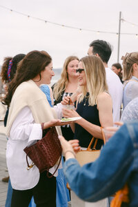 Candid guest interactions at a corporate brand event photographed in a natural, documentary style