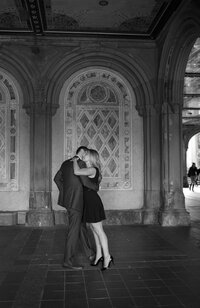 Central park engagement photos, Deborah Zoe Photography. A couple dance together in an archway in Central Park.