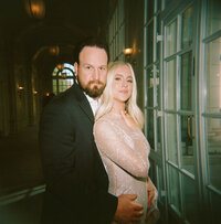 Editorial-style couple portrait in elegant hallway lighting captured in Huntsville, Alabama.