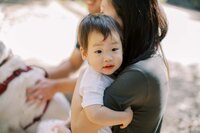 boy hugging mom and looking at camera