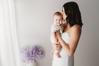 Charleston Mini Sessions - Mother embraces her baby during Mother's Day Mini Session at Holy City Babies in Charleston, SC.
